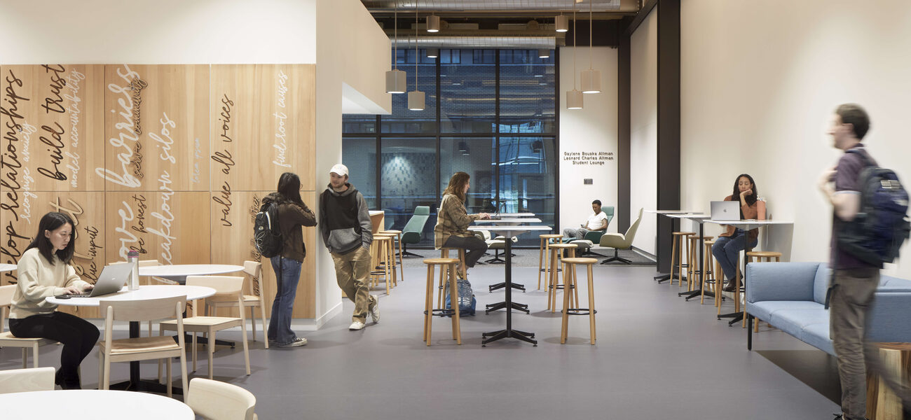 Students gather at small tables
