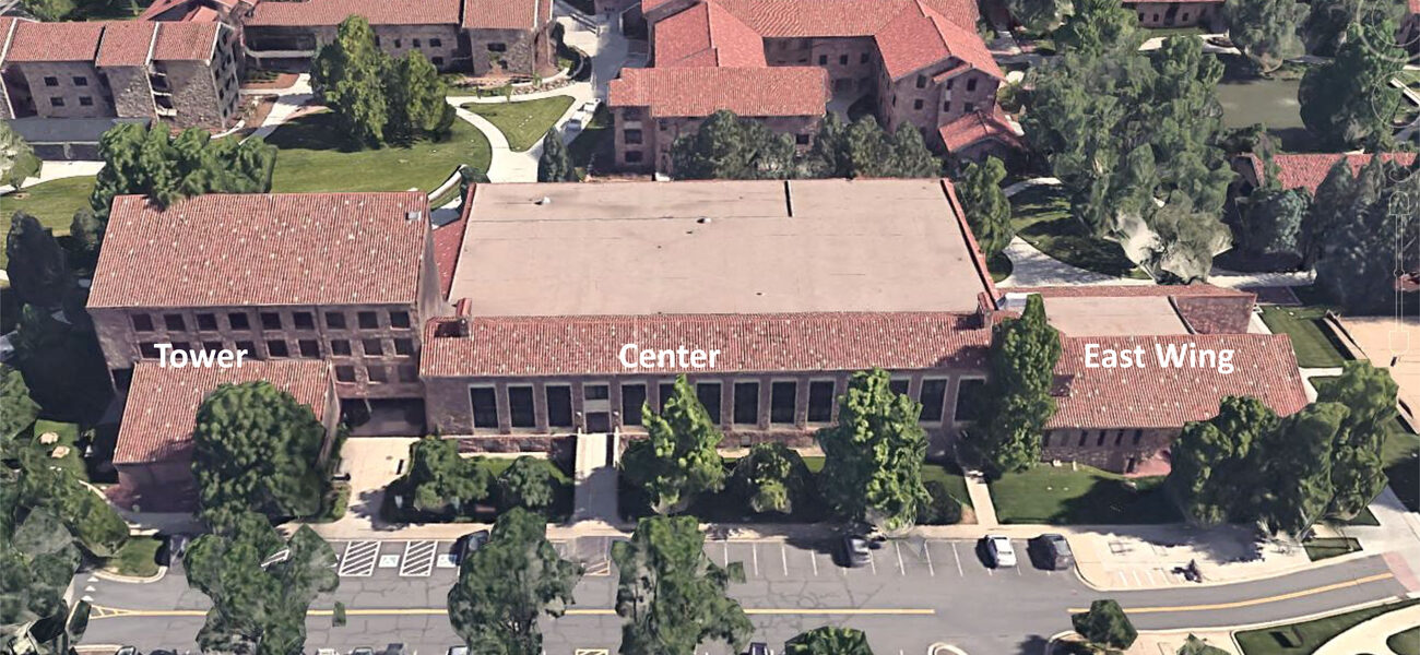 Aerial view of the building exterior, showing the tower on the left, the east wing on the right and a center section between them.
