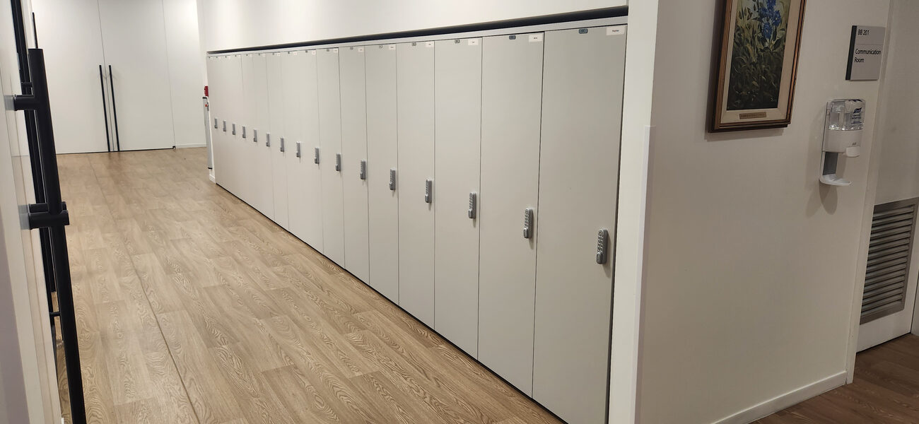 A long row of metal lockers lines an entire wall.