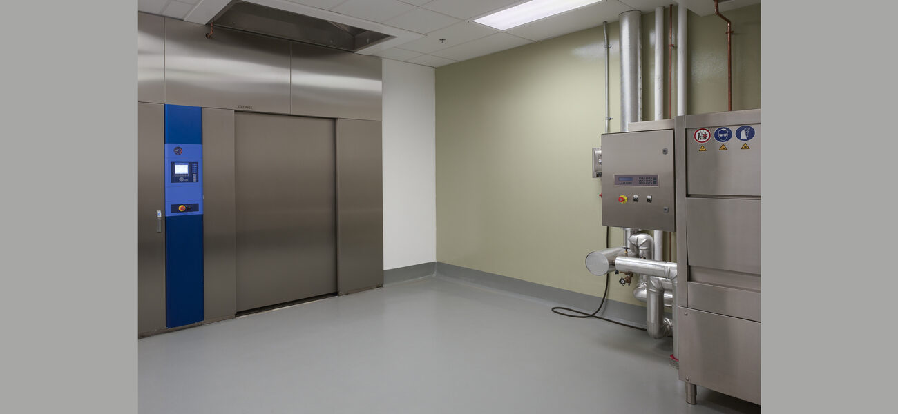 Nearly empty room with a piece of equipment against one wall.