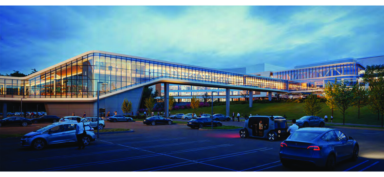 A long glass-enclosed bridge connects two buildings.