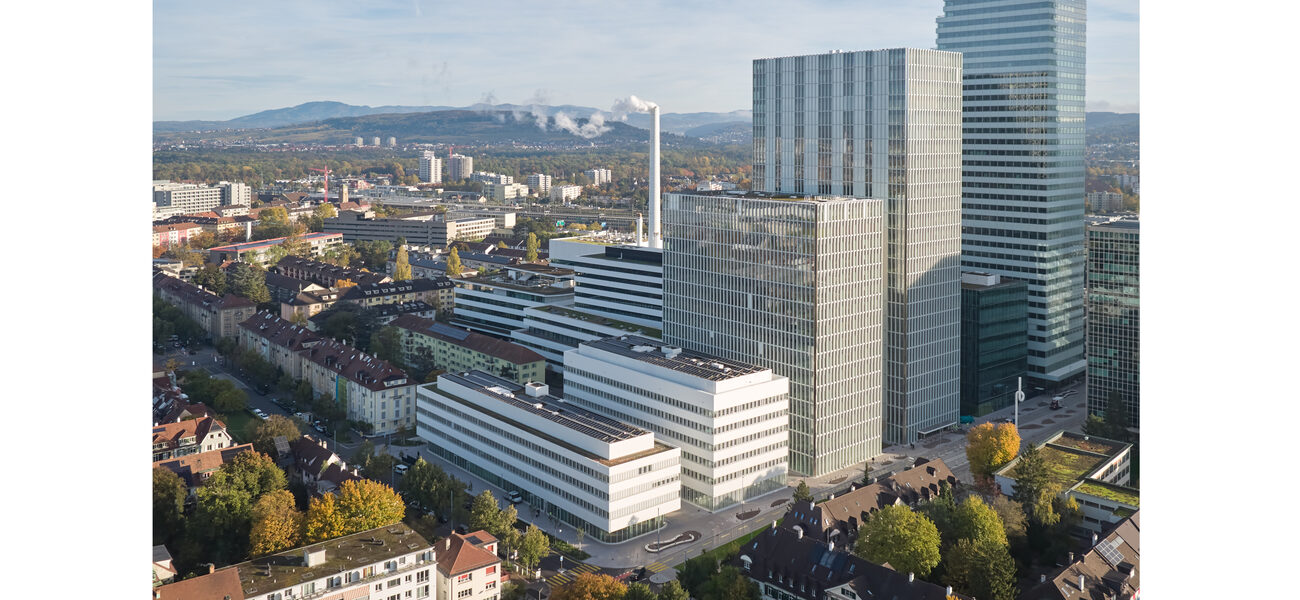 Aerial view of two low buildings in front of two towers