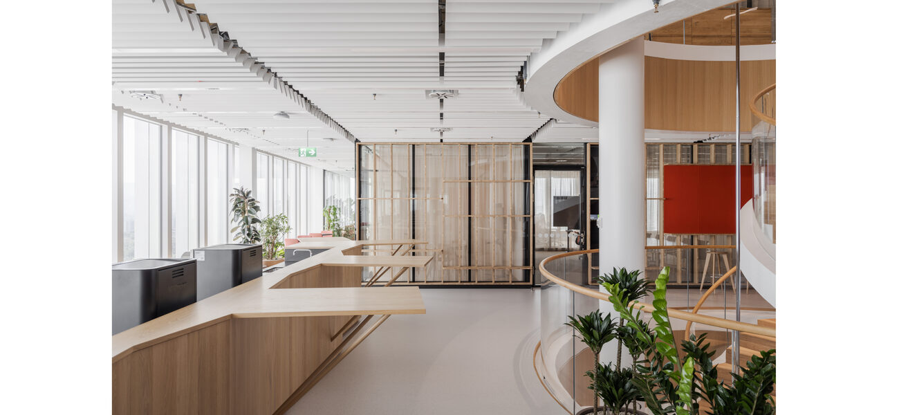 Large room with desktops along a wall of window