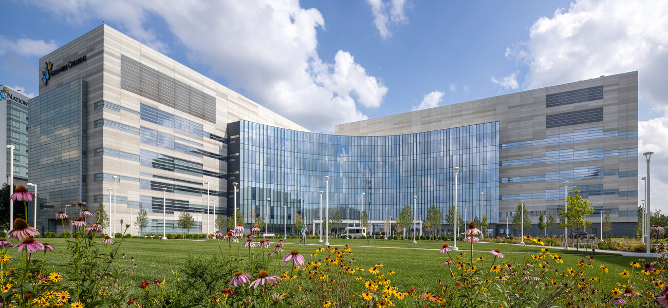 Large building with a curved glass front.