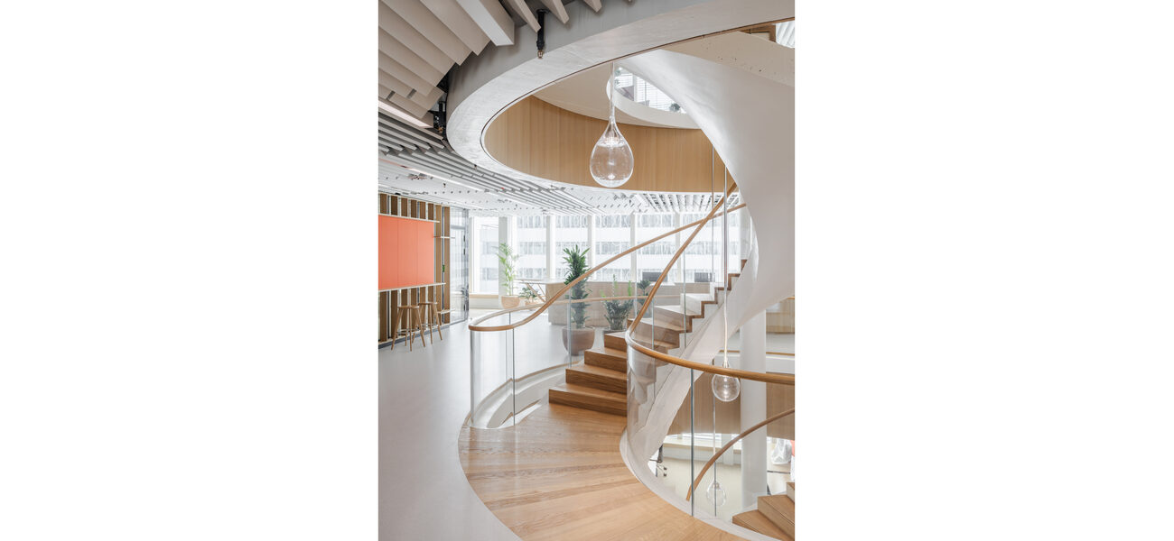 A spiral staircase winds from one floor to the next