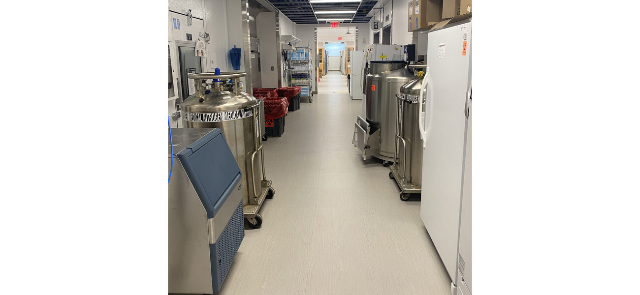 A hallway is lined with scientific equipment.