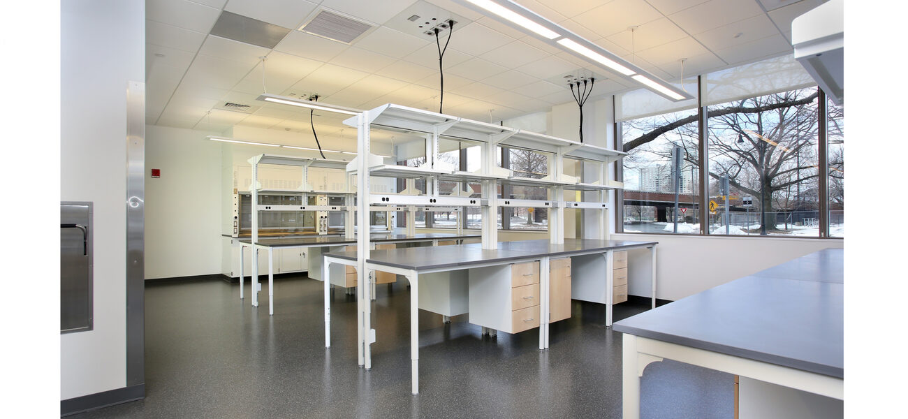 Empty lab benches in front of a large window.
