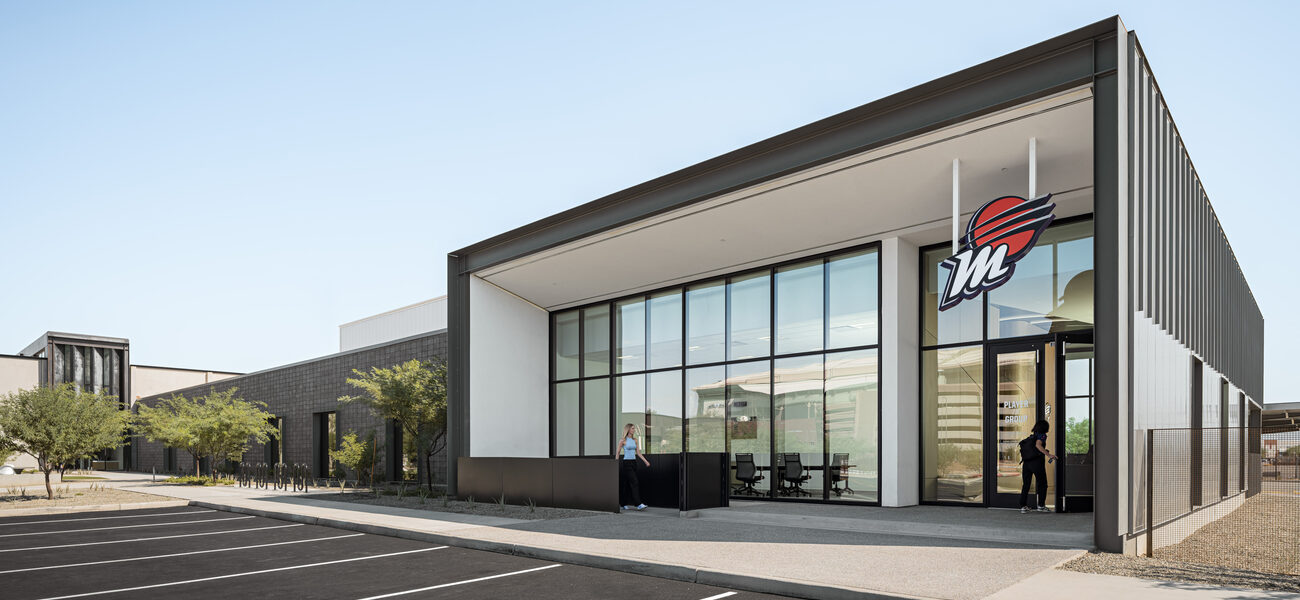 Building with a large glass front and a basketball logo.