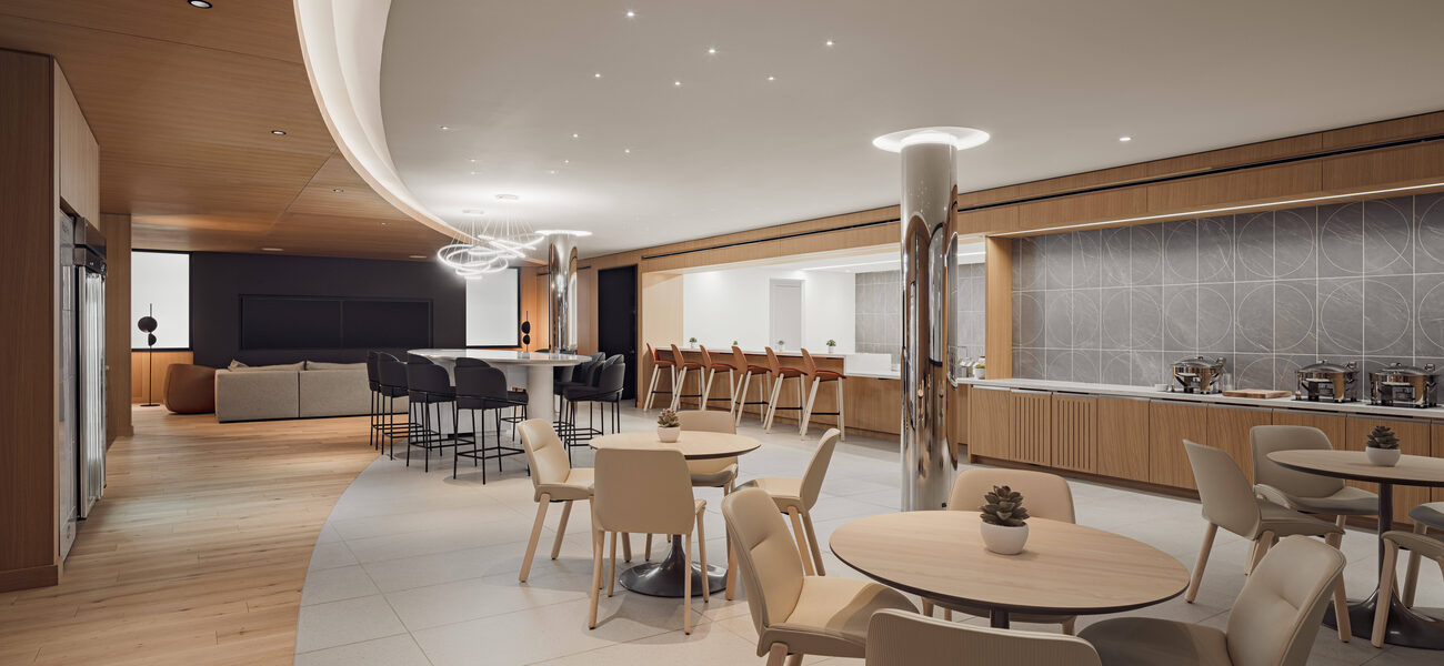 Very large room with tables and chairs and a long bar running along on wall.