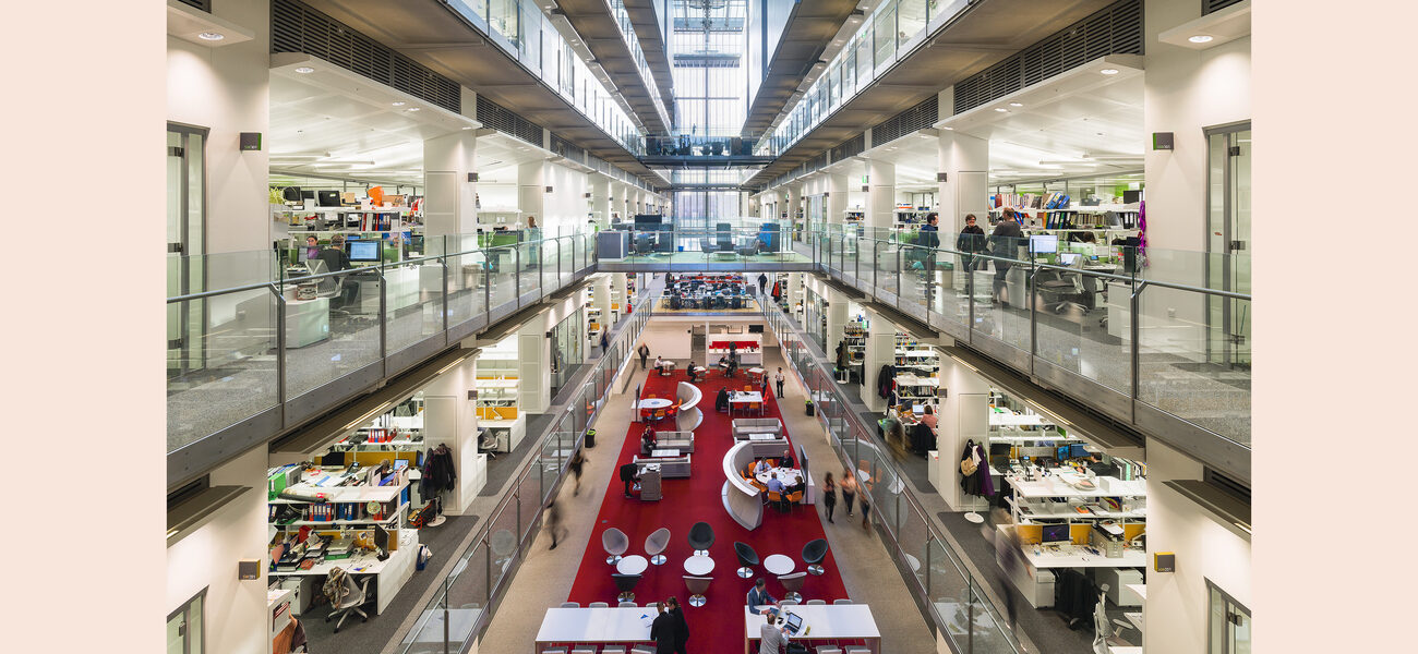 A large atrium containing tables and chairs of various sizes and shapes
