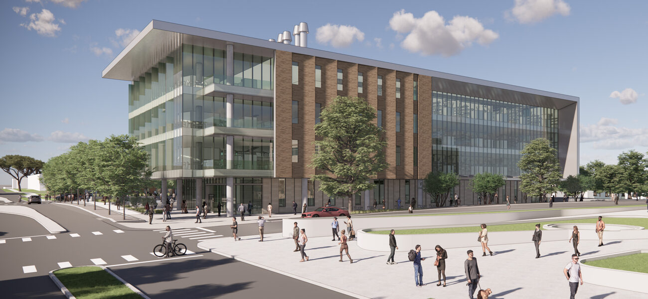 Large building covered in glass on each end with brick in the middle
