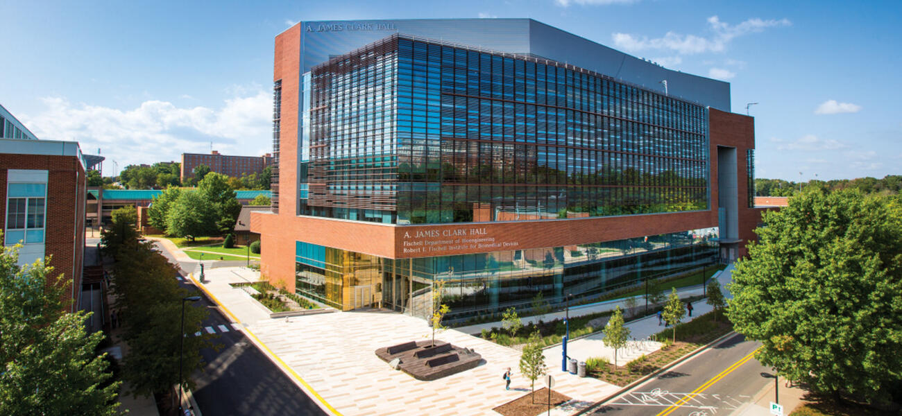 A large building lined mostly with glass and an outline of brick 