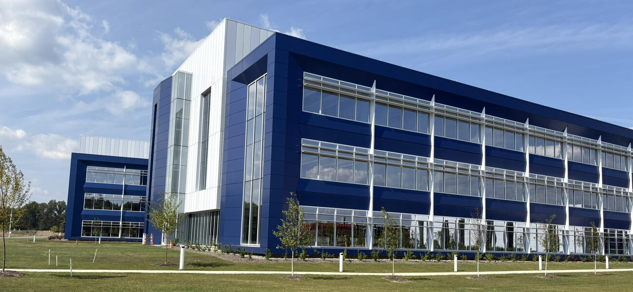 Long building with rows of windows along all three floors