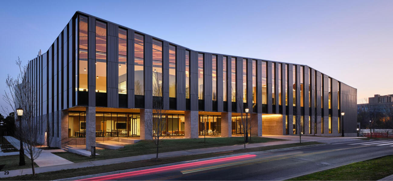 Exterior of large buildling lined with vertical windows.