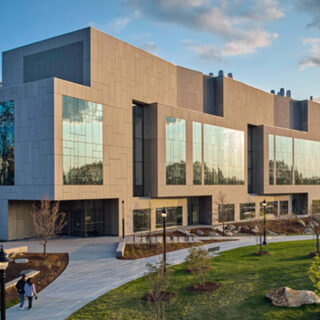 Building exterior, mostly concrete with large windows,