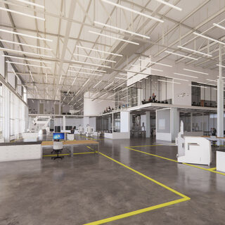 A large room with a high ceiling with several pieces of robotic equipment