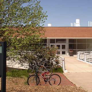 Low brick building with bicycles parked in front