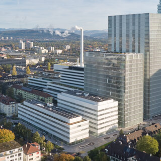 Aerial view of two low buildings in front of two towers