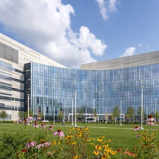 Large building with a curved glass front.